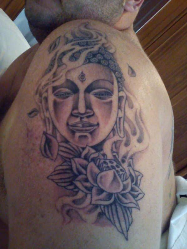 Buddhist face tattoo on half sleeve