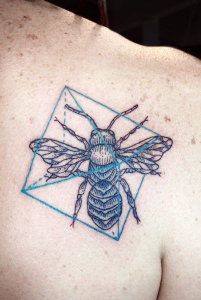 Bug and geometric symbols tattoo on shoulder blade
