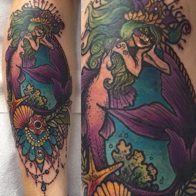 Carelessly painted colorful mermaid with flowers tattoo on leg muscle
