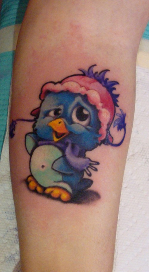Cartoon blue penguin tattoo on wrist