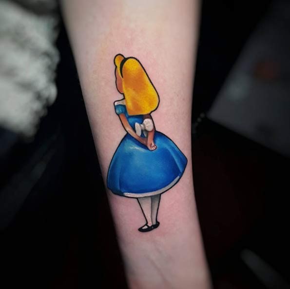 Cartoon forearm tattoo traditionally colored Alice in Wonderland