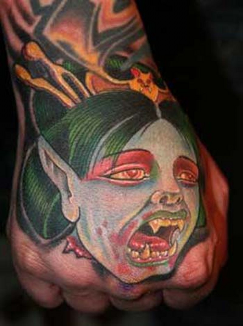 Cartoon like colored hand tattoo of vampire woman face