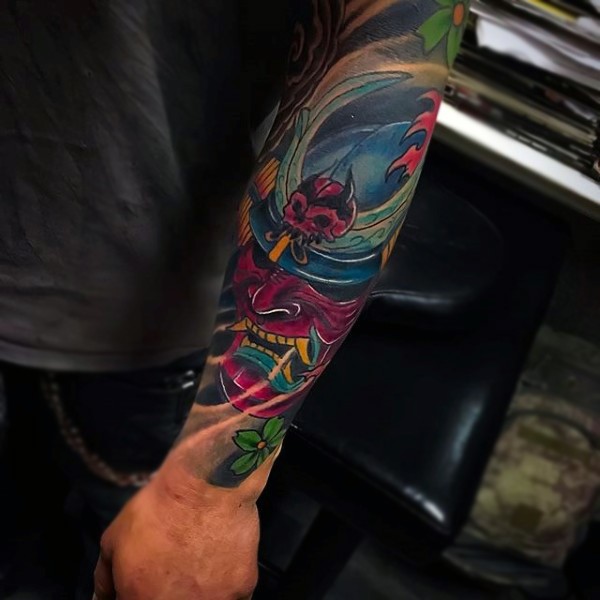 Cartoon like colored mystical samurai mask tattoo on forearm