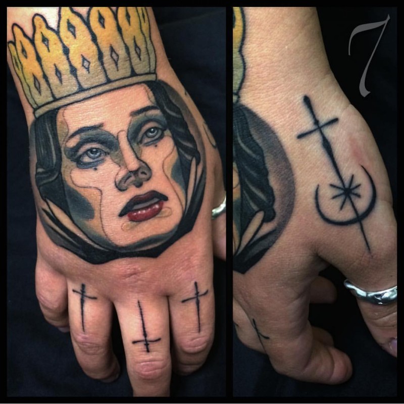 Cartoon like colored queen face tattoo on hand combined with various symbols