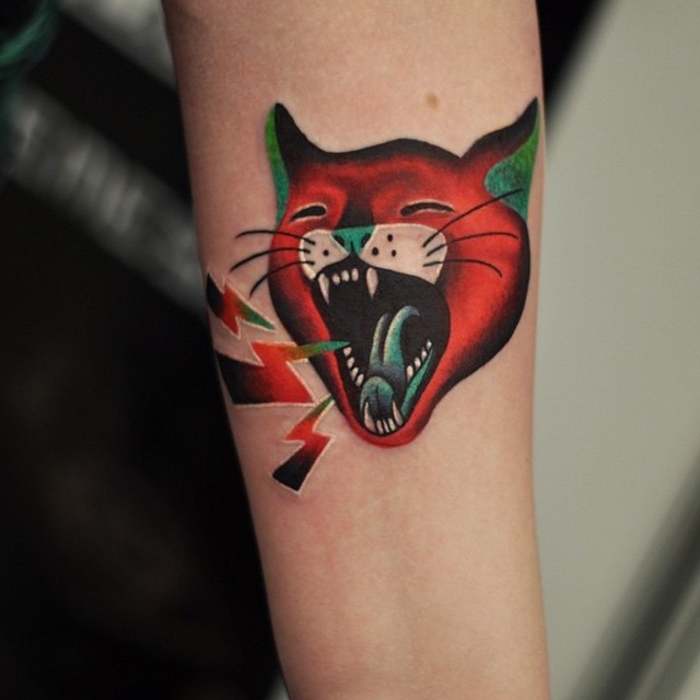 Cartoon like colored tiny screaming cat tattoo on forearm