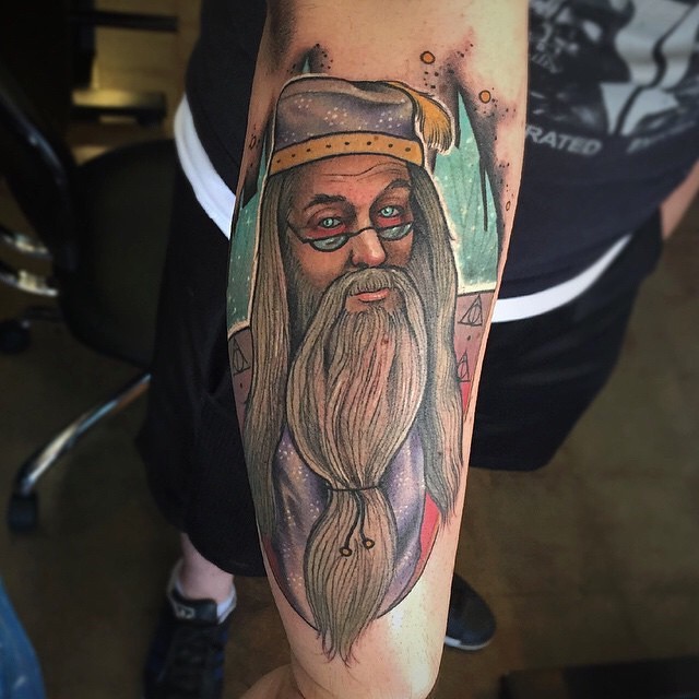 Cartoon like detailed and colored on forearm tattoo of Dumbledore