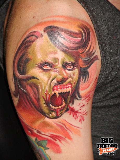 Cartoon like half zombie half vampire woman tattoo on shoulder