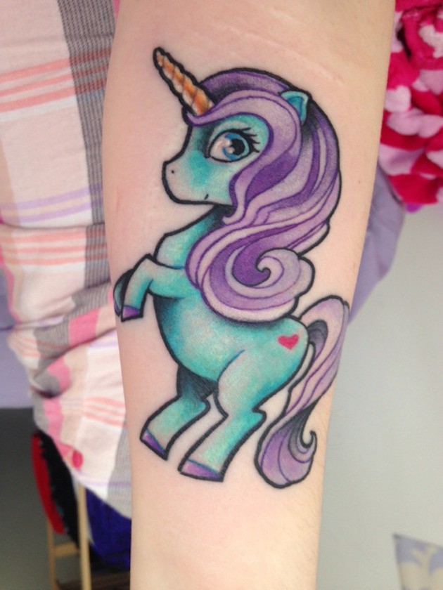 Cartoon like little colored forearm tattoo of baby unicorn