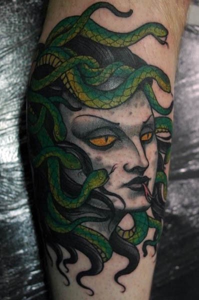 Cartoon like multicolored evil medusa head tattoo on leg