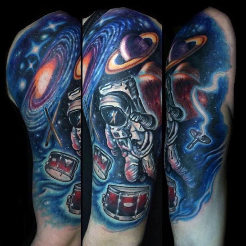 Cartoon like multicolored space with funny astronaut with drums tattoo on half sleeve area