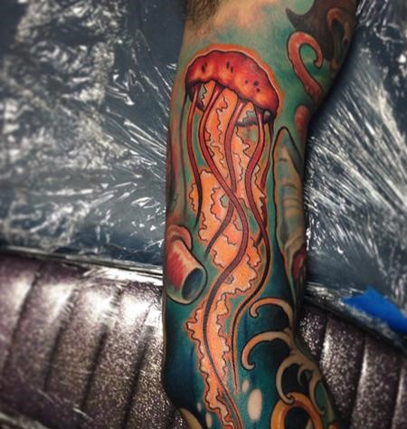Cartoon like simple colored big jellyfish tattoo on sleeve