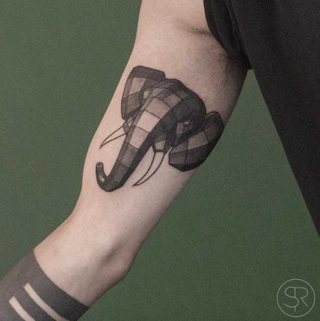 Cartoon style black ink elephant head tattoo on biceps