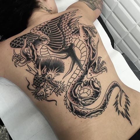 Cartoon style black ink whole back tattoo of fantasy dragon
