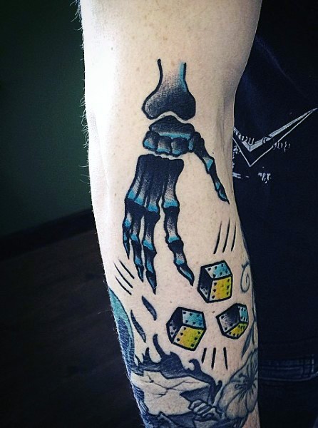 Cartoon style colored arm tattoo of skeleton hand with dice