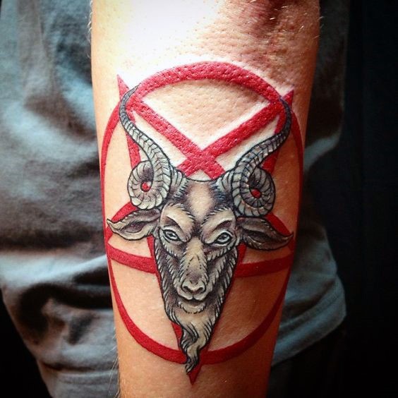 Cartoon style colored arm tattoo of devils goat with red star