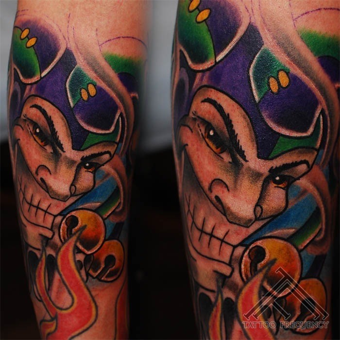 Cartoon style colored arm tattoo of evil Joker