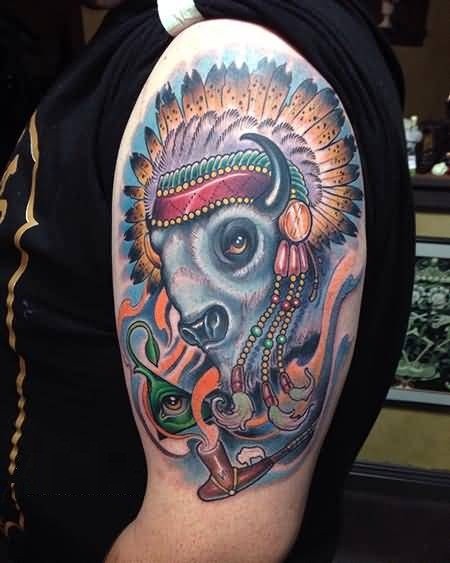 Cartoon style colored big Indian bison on shoulder tattoo with mystical pyramid and smoking pipe