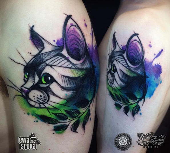 Cartoon style colored shoulder tattoo of cat with leaf