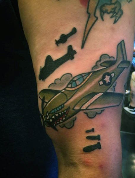 Cartoon style colored shoulder tattoo of fighter plane