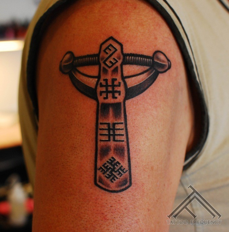 Cartoon style colored shoulder tattoo of ancient statue with symbols