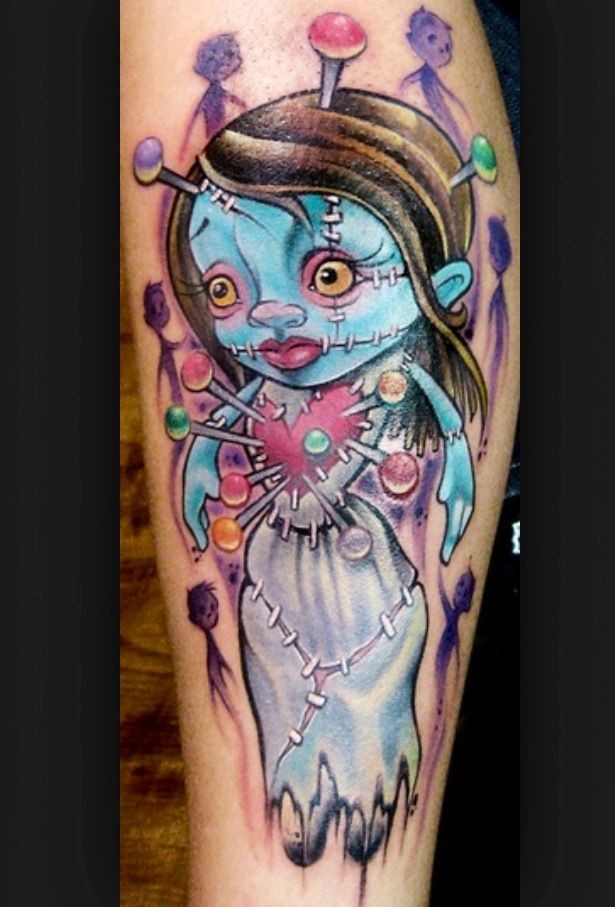 Cartoon style colored tattoo of doll with needles