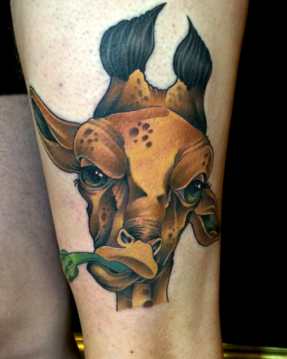 Cartoon style colored thigh tattoo of giraffe eating plant