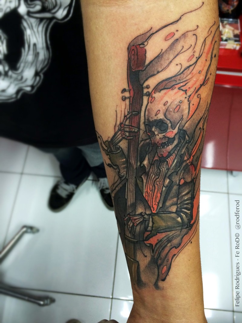 Cartoon style forearm tattoo of burning skeleton musician