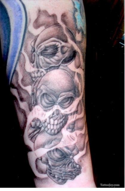 Tatuaje en el brazo,
cráneos misteriosa en la niebla