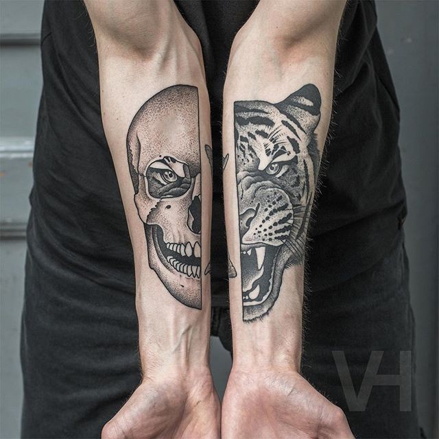 Cartoon style painted by Valentin Hirsch black ink forearms tattoo of split tiger head with human skull