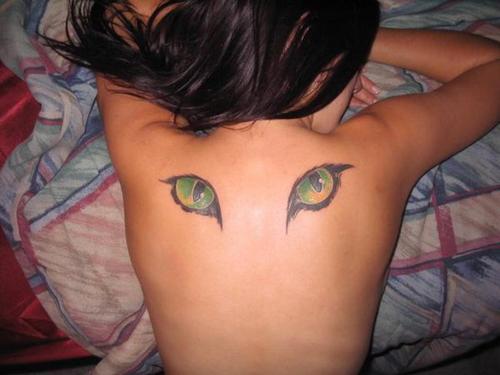Coloured cat eyes tattoo on back