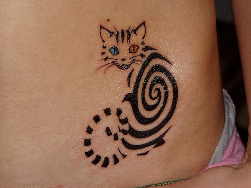 Spiral cat tattoo with blue and red eyes