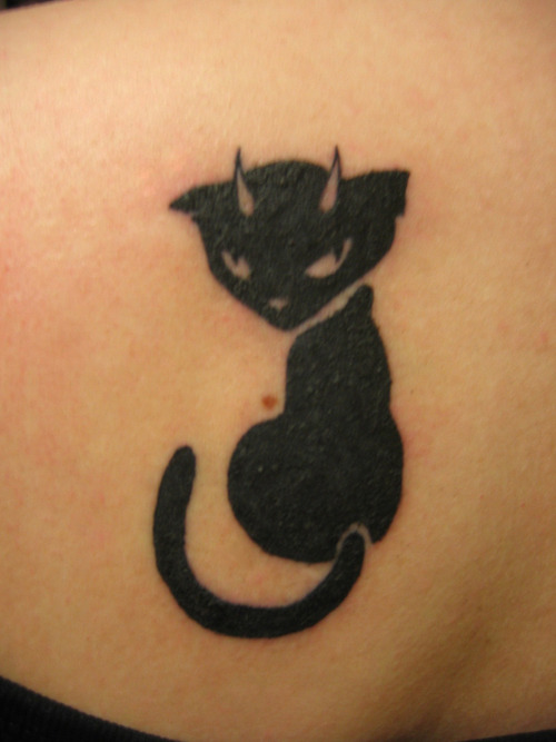Black cat with small horns tattoo