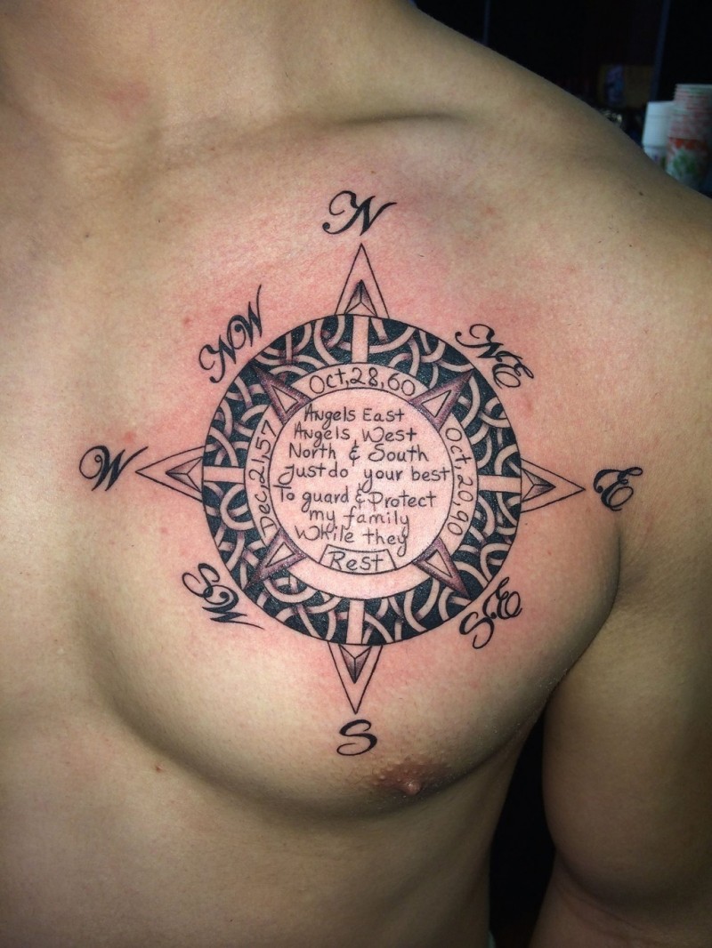 Celtic style black and white symbol tattoo on chest with lettering