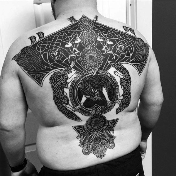 Celtic style black ink back tattoo of various ornaments