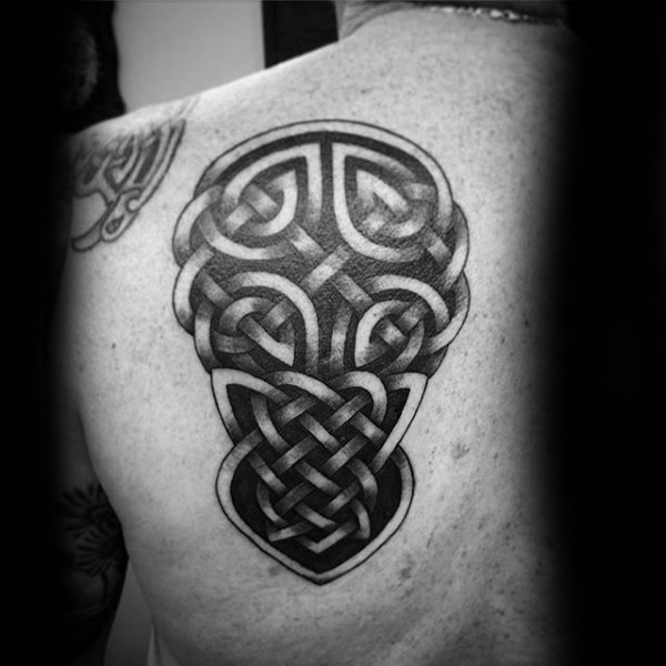 Celtic style black ink scapular tattoo of various knots