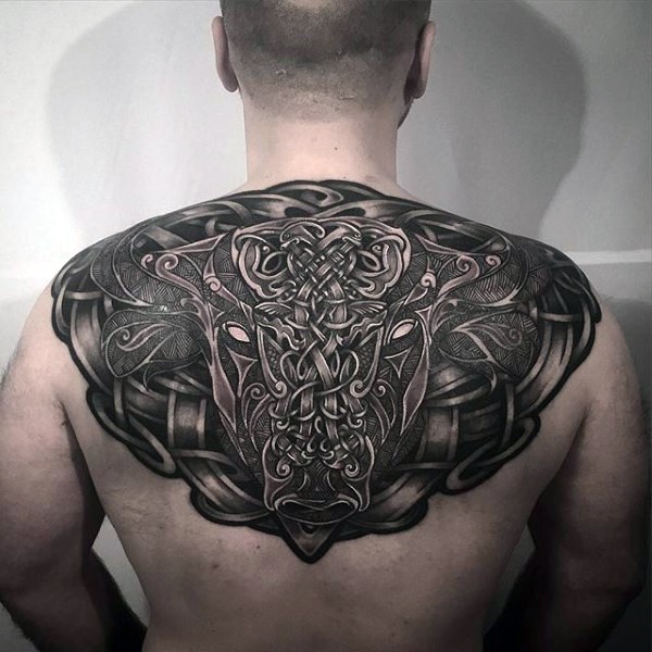 Celtic style colored upper back tattoo of big bull with various symbols