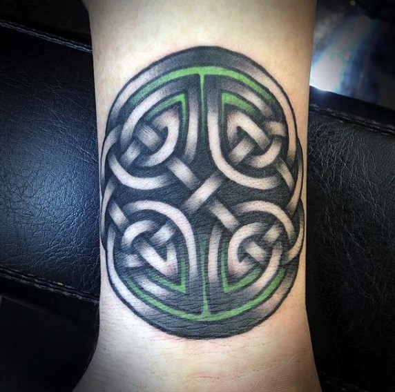 Celtic style colored wrist tattoo of interesting symbol