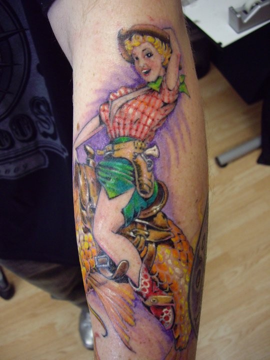 Cheerful cowgirl pin up tattoo by Dennis Kline