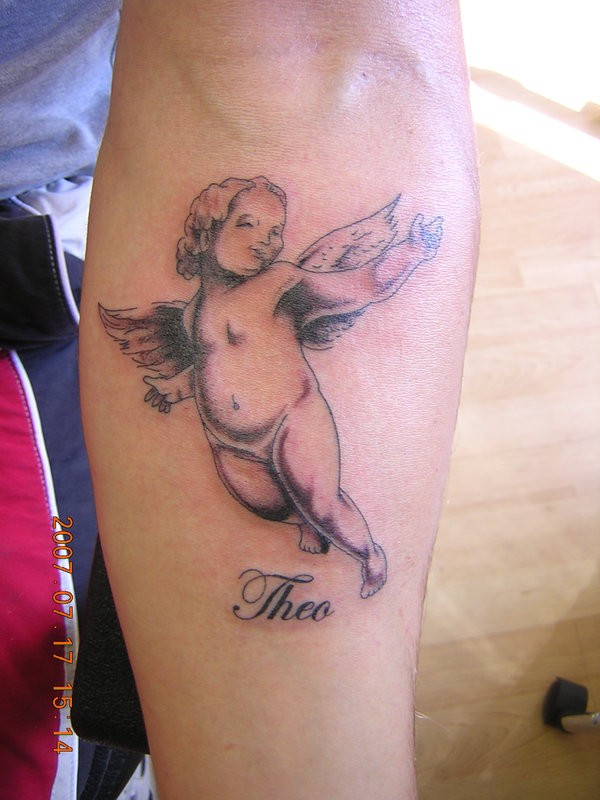 Cherub baby and name tattoo on leg