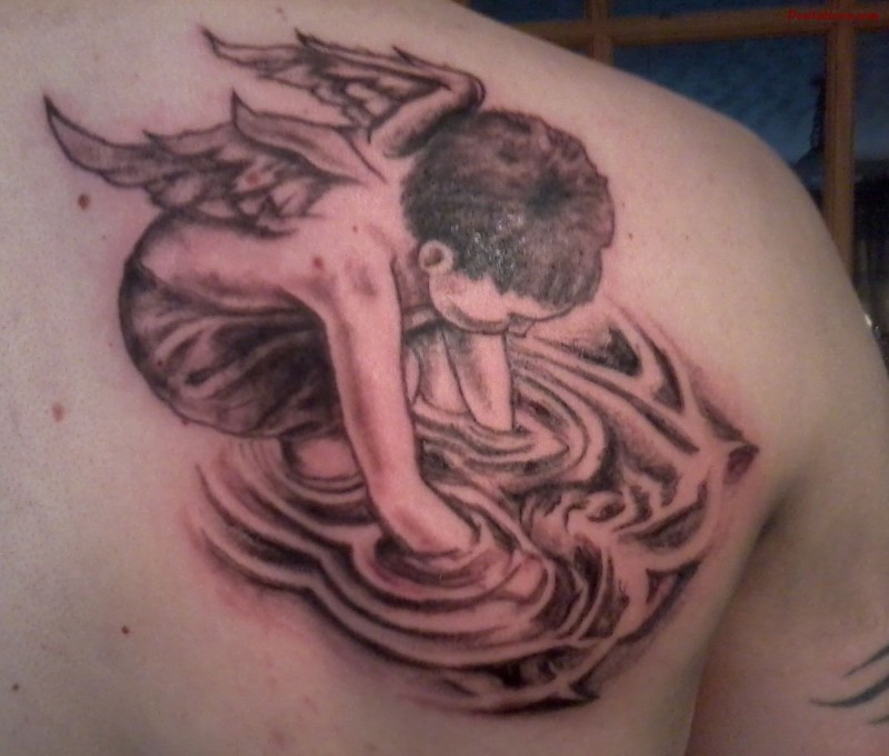 Cherub looks at reflection in water tattoo on shoulder blade