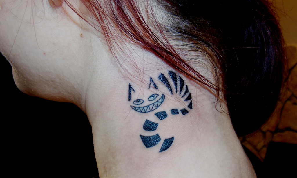 Half visible cheshire cat tattoo on neck