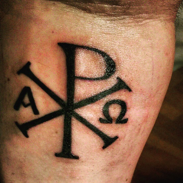 Christ monogram tattoo in dark black ink