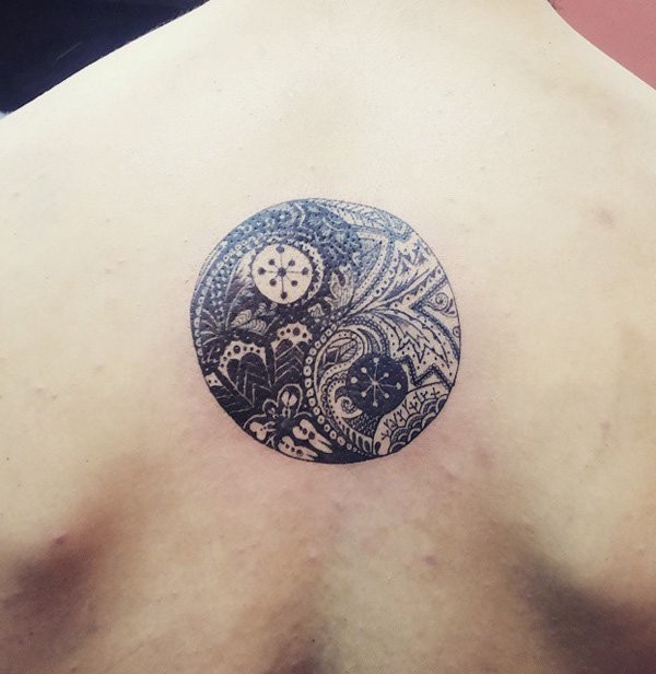 Circle shaped beautiful looking back tattoo stylized with ornaments