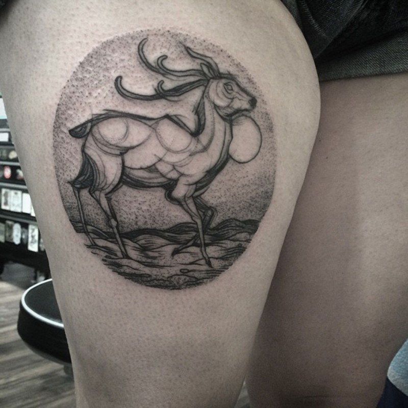 Circle shaped black ink thigh tattoo of big deer and desert