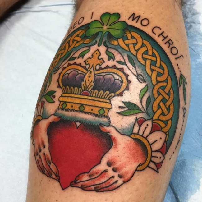 Circle shaped colored leg tattoo of Celtic symbols with heart with crown