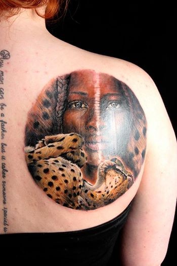 Circle shaped colored scapular tattoo of woman with leopard