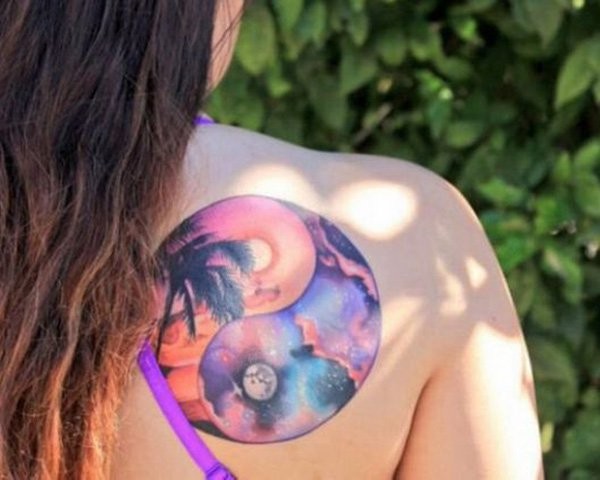 Circle shaped colored shoulder tattoo of night sky and palm tree