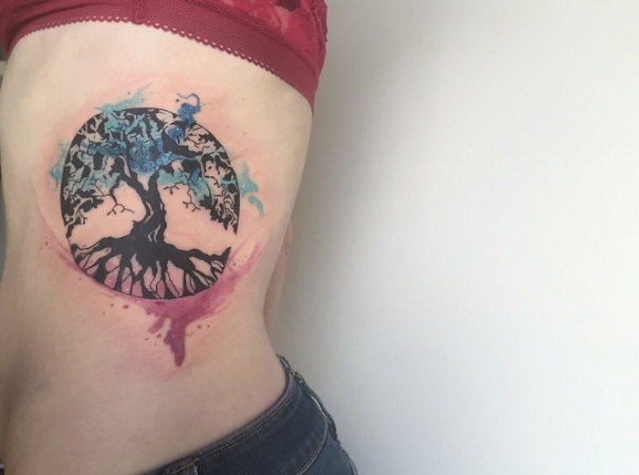 Circle shaped colored side tattoo of tree