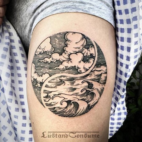 Circle shaped engraving style thigh tattoo of waves and clouds