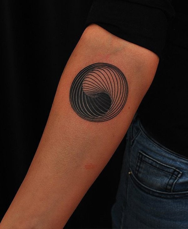 Circle shaped forearm tattoo of Yin Yang shaped symbol
